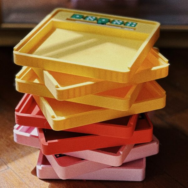 Picture of 9 yams board games, with 4 yellow, 2 oranges and 3 pink